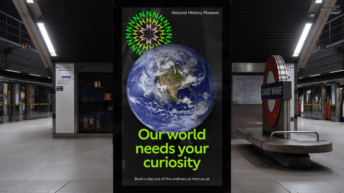 An NHM billboard advertisement in a London station, featuring bold colourful designs and featuring the Earth.