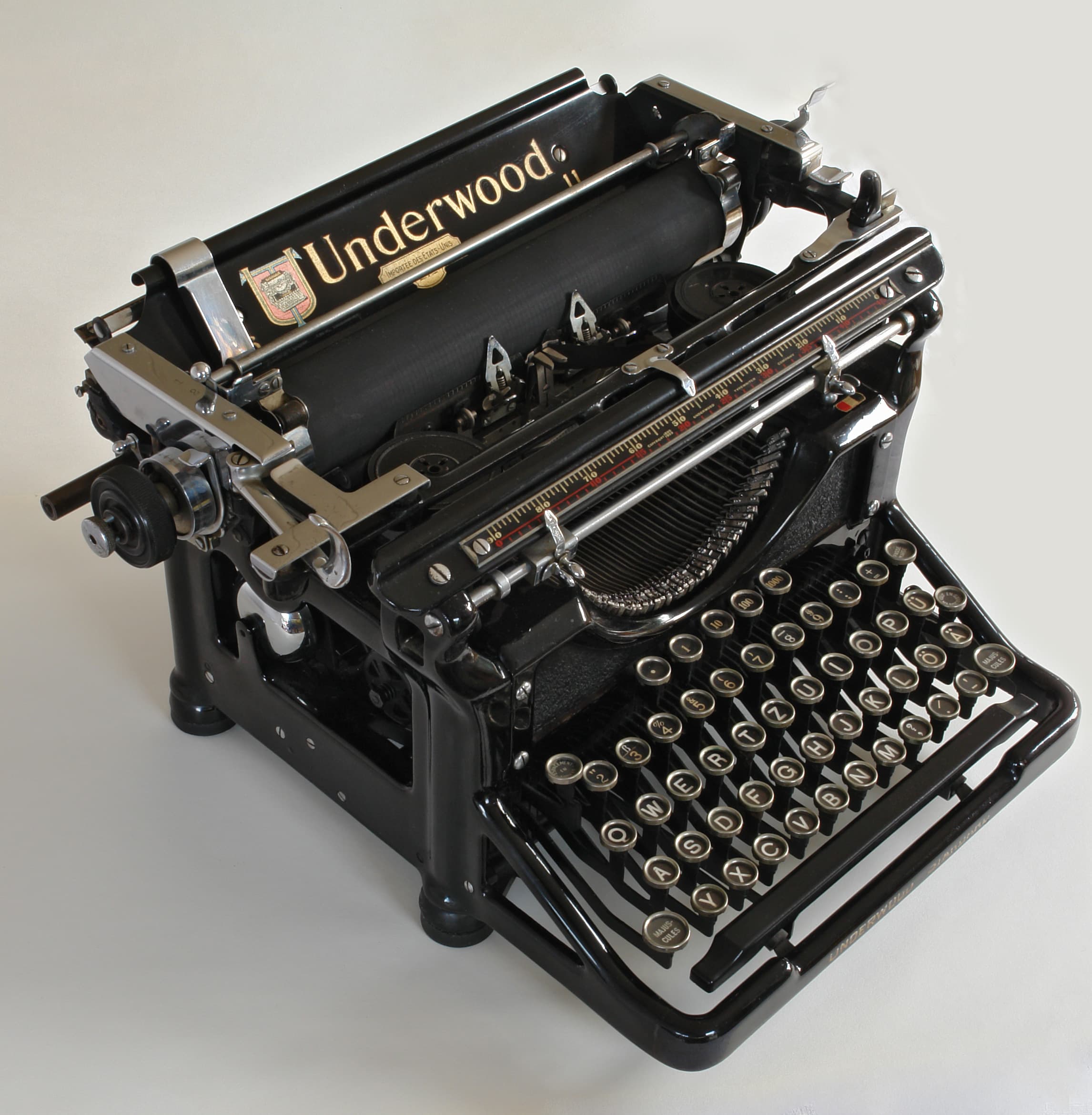 An Underwood typewriter photographed against a white background, showing its rows of circular keys and mechanical carriage.